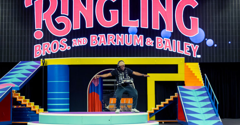 Photo of Lucky performing in front of a Ringling light